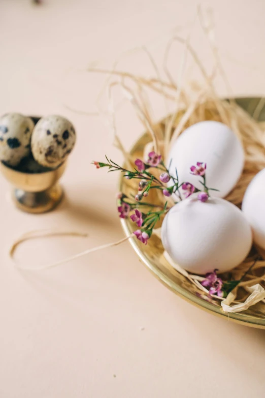 a bowl filled with eggs sitting on top of a table, flowers, item, ornament, food