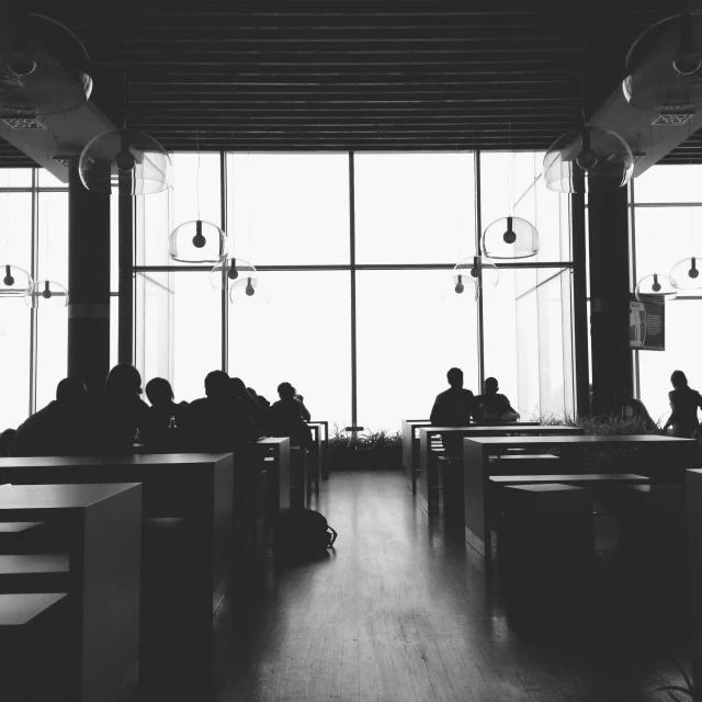 a black and white photo of people sitting at tables, pexels, light and space, gloomy library, beautiful sunny day, silhouette :7, food court