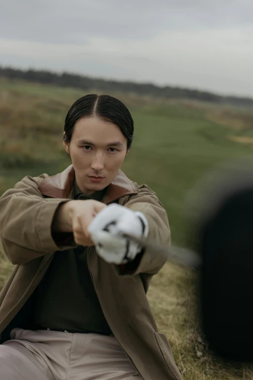 a woman sitting on the ground holding a baseball bat, inspired by Fei Danxu, adam driver behind, pointing a pistol, shot from above, bbc