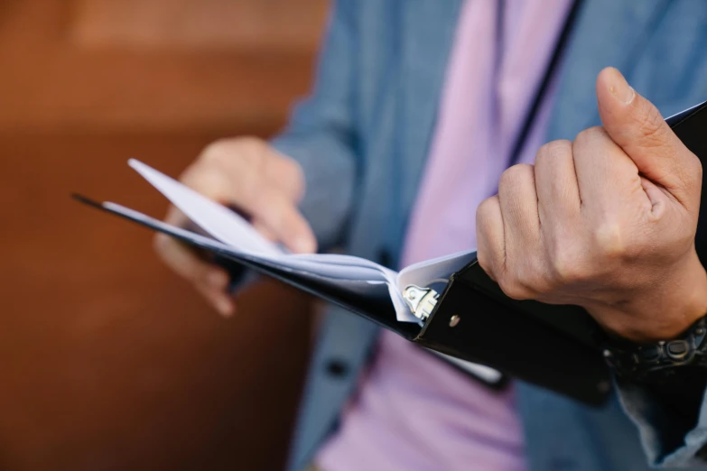 a close up of a person holding a piece of paper, unsplash, hurufiyya, holding a clipboard, serious business, thumbnail, multiple stories