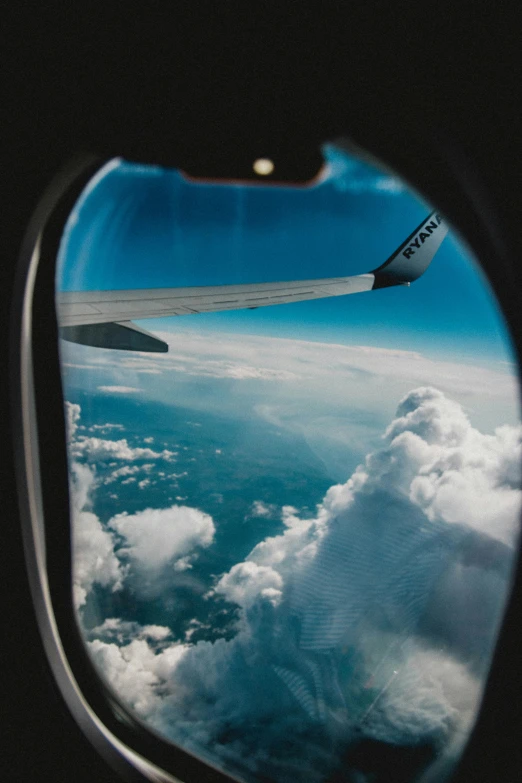 a view of the sky through an airplane window, pexels contest winner, clouds and wings and waves, taken in 2022, instagram post, conde nast traveler photo