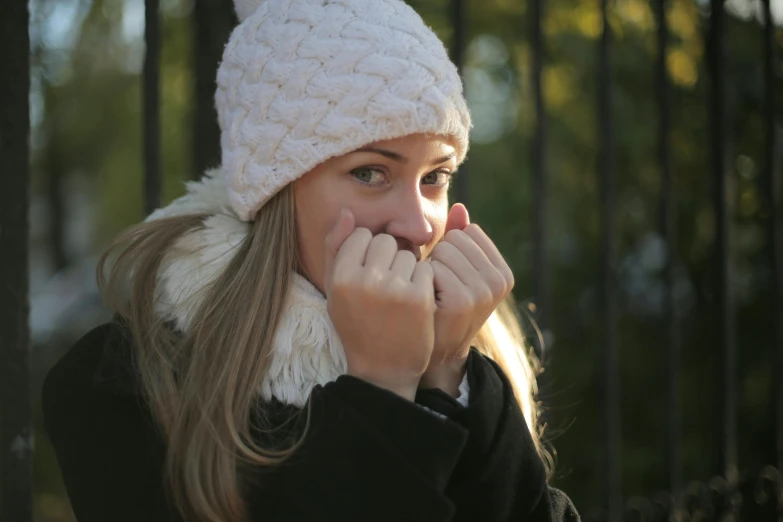 a woman in a white hat talking on a cell phone, by Alice Mason, pexels, beanie hat, girl with white eyes, square, a blond