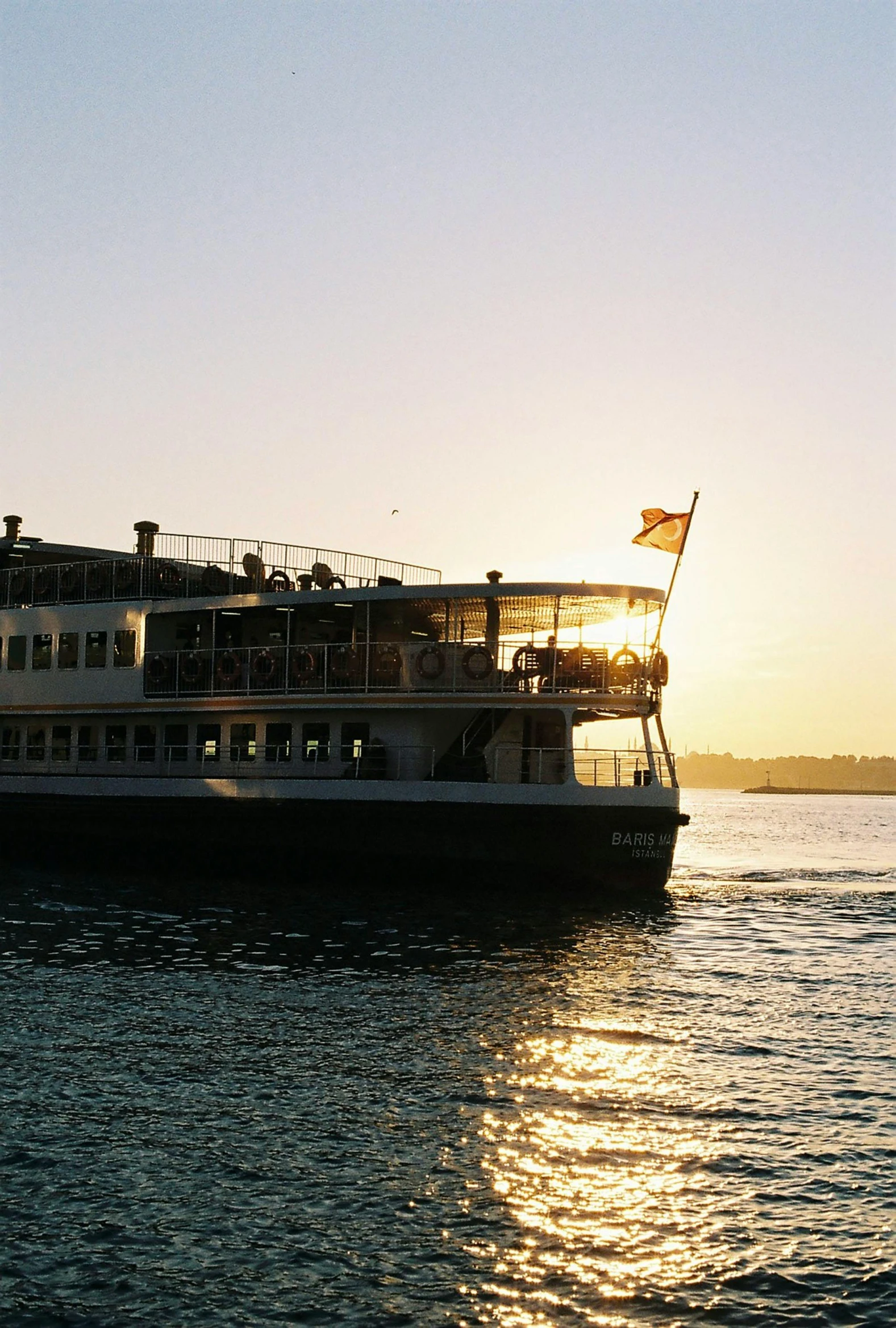 a large boat floating on top of a body of water, hurufiyya, in the sunset, sydney, the empress, manly