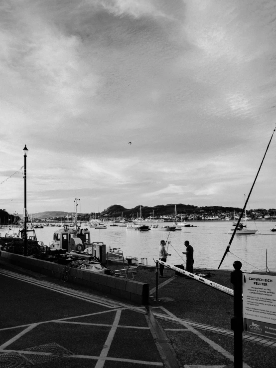 a black and white photo of a harbor, a black and white photo, by John Henderson, unsplash, happening, holywood scene, shot with iphone 1 0, taken from the high street, square