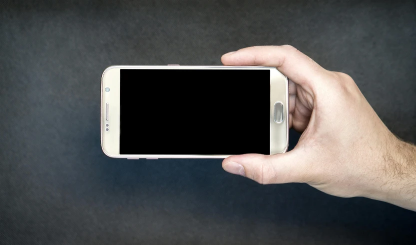 a close up of a person holding a cell phone, by Matthias Stom, pixabay, square, holding a galaxy, wide-screen, no - text no - logo