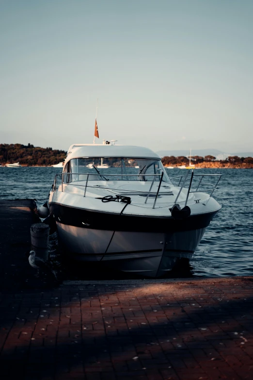 a white boat sitting on top of a body of water, happening, docked at harbor, low quality photo, shot on sony a 7, ibiza