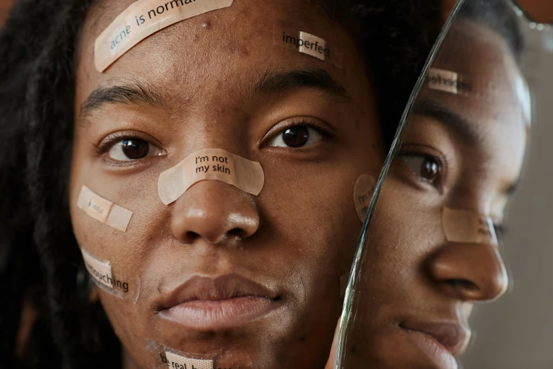 a close up of a person with tape on their face, trending on pexels, black teenage boy, full of mirrors, a labeled, womanhood”