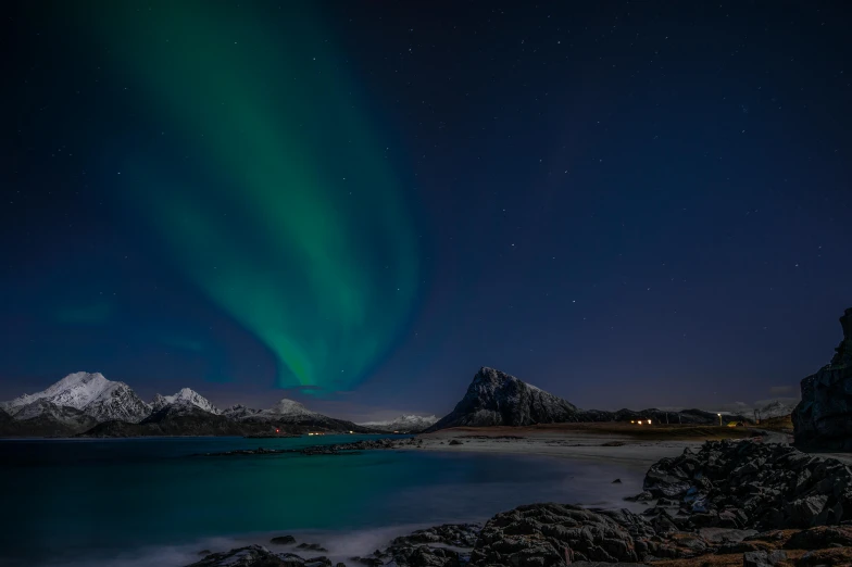 the aurora lights in the sky over a body of water, by Sebastian Spreng, pexels contest winner, mountains and ocean, moonlight grey, high quality photo, blue and green