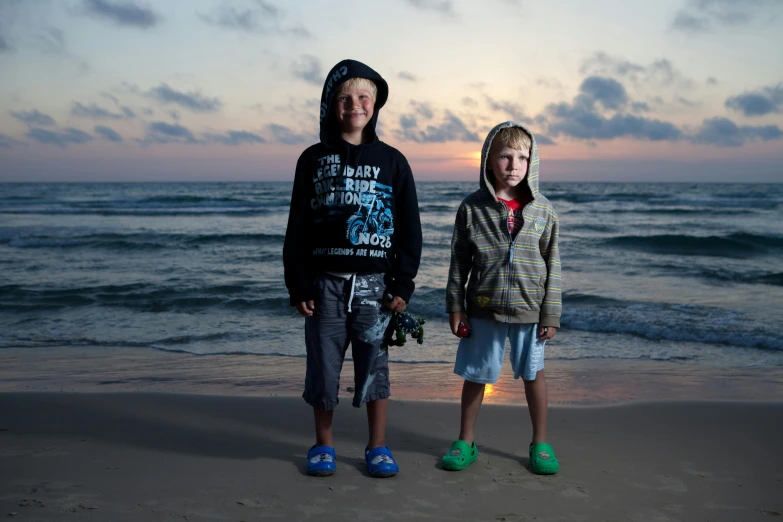 a couple of kids standing on top of a sandy beach, a portrait, by Michael Goldberg, pexels contest winner, hyperrealism, during dawn, boys, avatar image, print ready