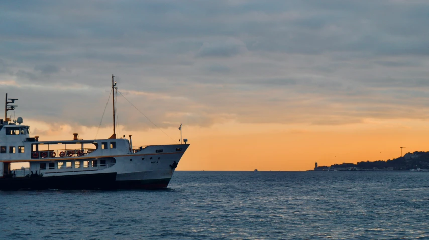 a large boat floating on top of a body of water, pexels contest winner, renaissance, dusk light, scylla and charybdis, on a super yacht, tallinn