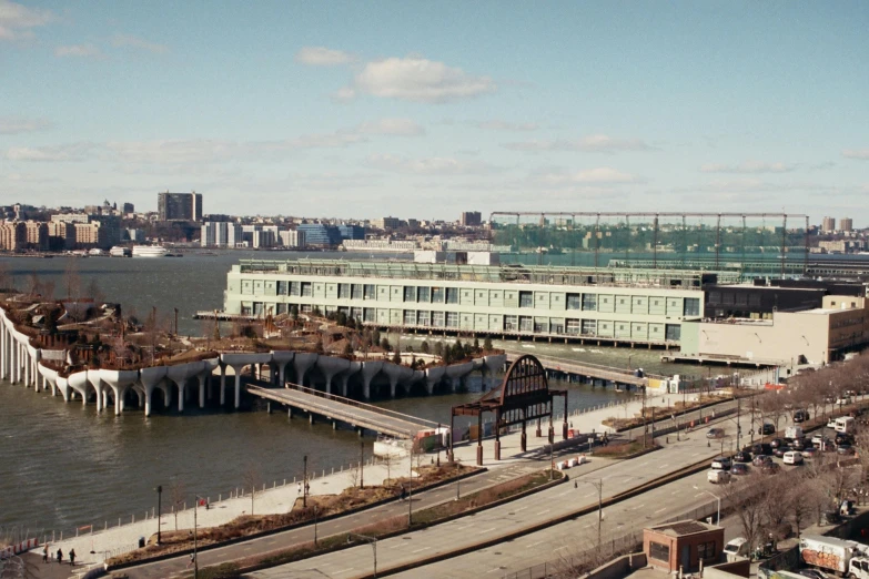 a large body of water next to a city, a colorized photo, inspired by Robert Bechtle, featured on vimeo, city docks, ignant, metmuseum