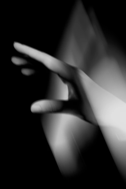 a black and white photo of a hand reaching for something, inspired by Lillian Bassman, refracted lighting, anna dittman, self erotic, volumetric light ， surreal