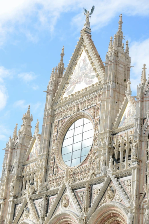 a large cathedral with a clock on top of it, inspired by Taddeo Gaddi, renaissance, buttresses, silver, sienna, photograph