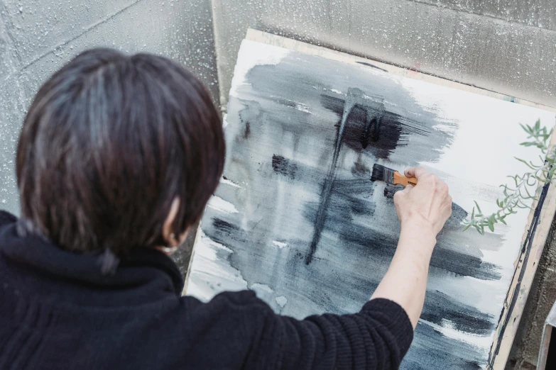 a woman is painting a picture on a canvas, inspired by Kanō Naizen, unsplash, arbeitsrat für kunst, grey, glazing, aoi ogata, rectangle