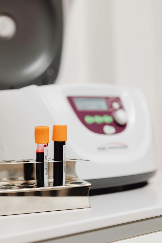 a row of test tubes sitting on top of a counter, a picture, by Jakob Gauermann, cover with blood, digital medical equipment, plasma, brown