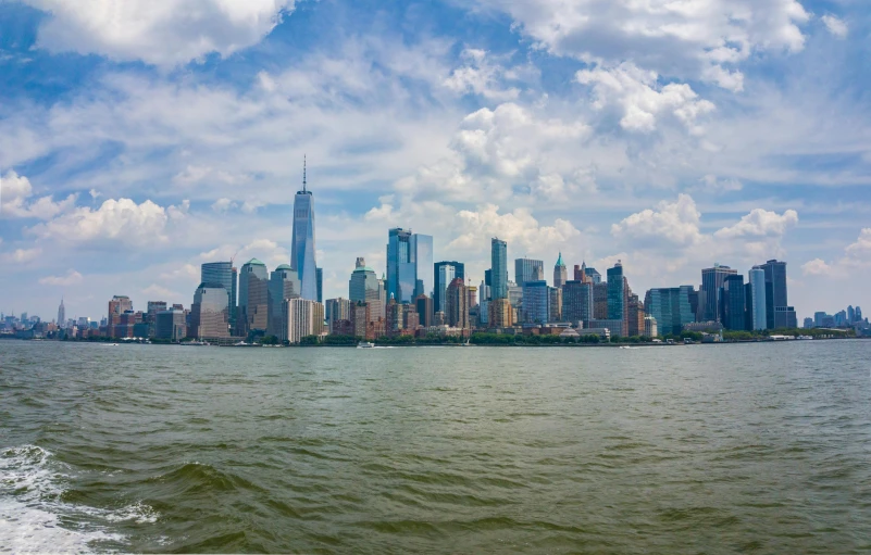 a large body of water with a city in the background, a picture, new york backdrop, gopro photo, high-resolution photo, 8k resolution”