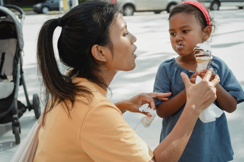 a woman feeding a child an ice cream cone, pexels contest winner, realism, south east asian with round face, brown, thumbnail, nursing