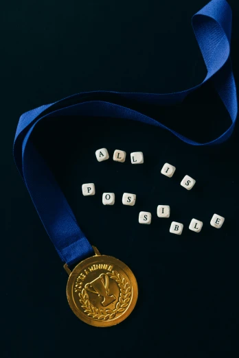 a gold medal sitting on top of a blue ribbon, poster art, by artist, pexels contest winner, cubes on table, letters, sports photo, crypto
