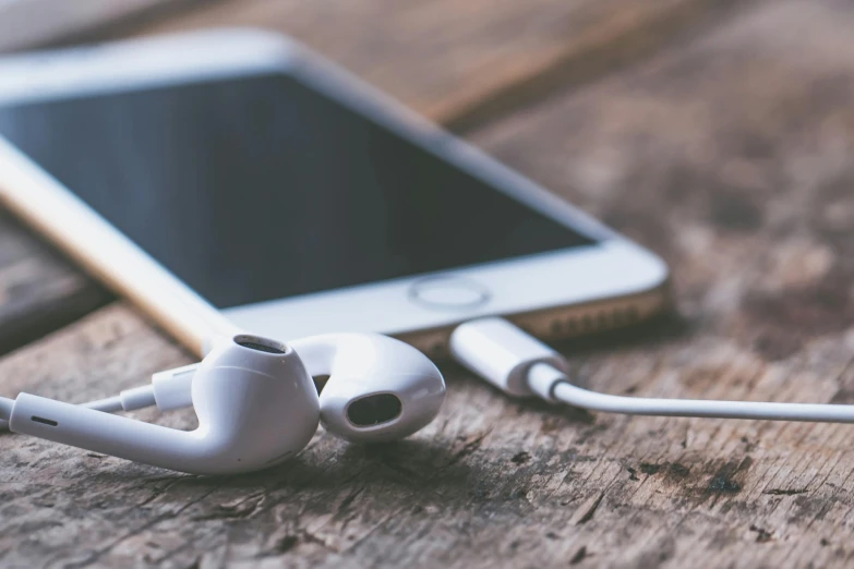 a pair of headphones sitting on top of a wooden table, trending on pexels, beautiful iphone wallpaper, avatar image, with a white, digital medical equipment