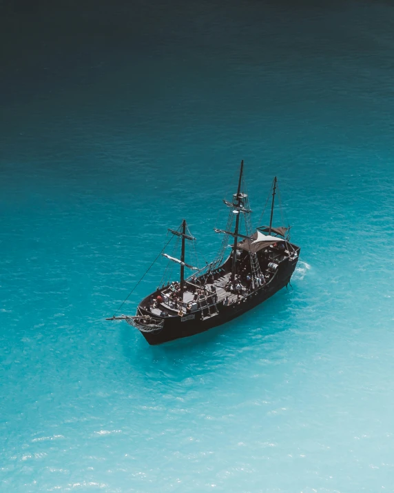 a boat floating on top of a body of water, pirate ship, flatlay, black and cyan color scheme, thumbnail