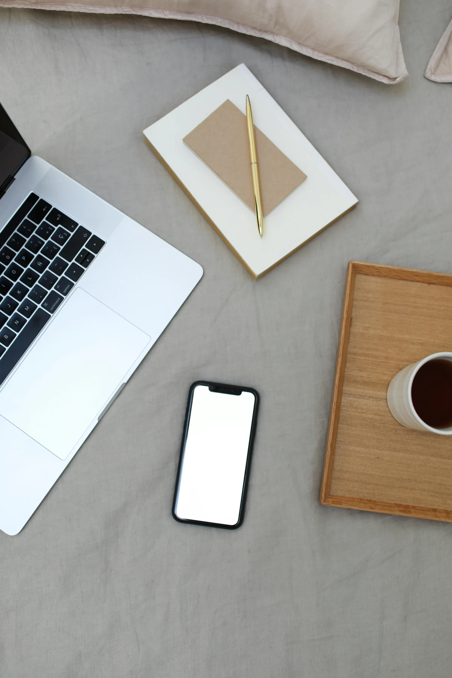 a laptop computer sitting on top of a bed next to a cup of coffee, 9 9 designs, no - text no - logo, curated collections, brown