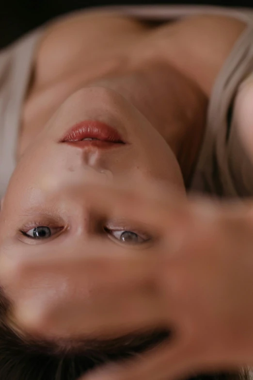 a close up of a person laying on a bed, inspired by Anna Füssli, trending on pexels, hyperrealism, mirrored, eyes and lips, vfx film closeup, two still figures facing camera