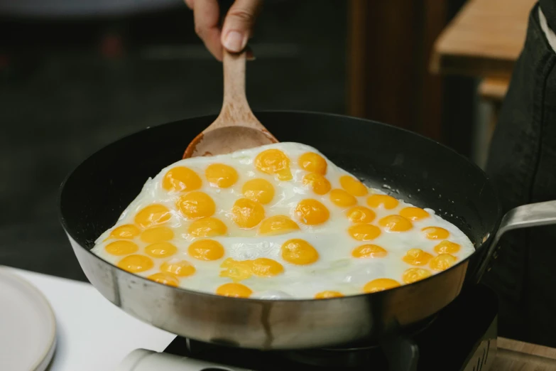 a frying pan filled with eggs on top of a stove, a cartoon, trending on unsplash, hurufiyya, halo halo halo halo 8k, 🦩🪐🐞👩🏻🦳, made of cheese, asian male