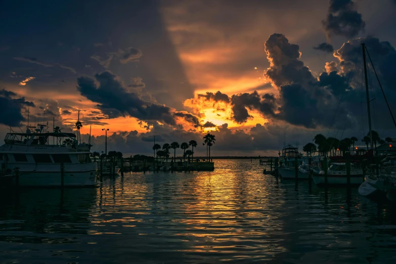 a group of boats sitting on top of a body of water, by Bernie D’Andrea, pexels contest winner, romanticism, cloudy sunset, florida, bursting with holy light, harbor