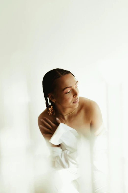 a woman in a white dress is brushing her hair, an album cover, inspired by Theo Constanté, unsplash, mixed-race woman, dewy skin, morning light, shot on sony a 7