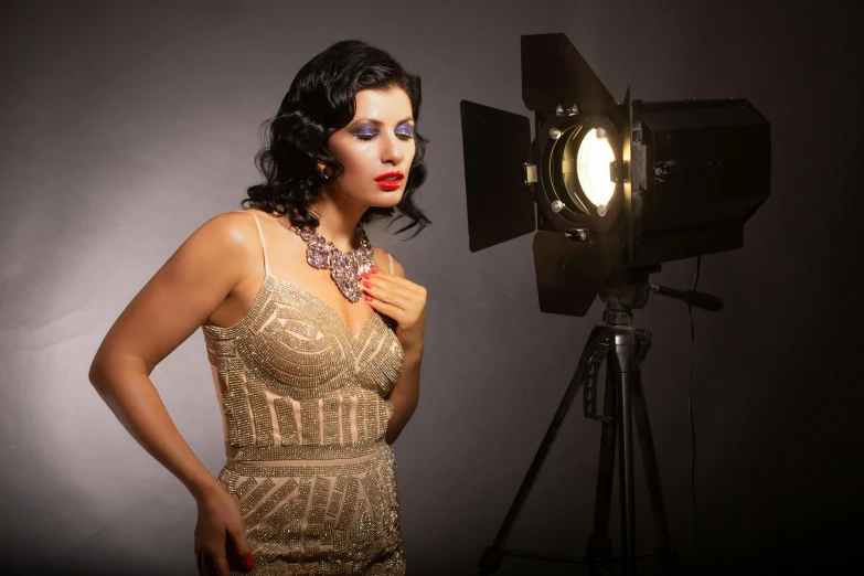 a woman posing in front of a camera, a portrait, inspired by George Hurrell, pixabay, indian super model, art deco era), cinematic outfit photo, meet the actor behind the scenes