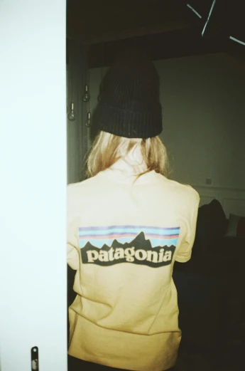 a woman taking a picture of herself in a mirror, a polaroid photo, by Pablo Rey, happening, trending on r/streetwear, back view, patagonian, it's wearing a cute little hat