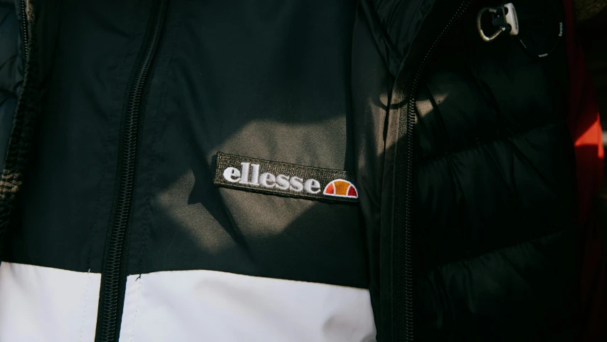 a close up of a person wearing a jacket, inspired by Eugène Brands, glassy, white and black, sealed since 1989, dusk setting