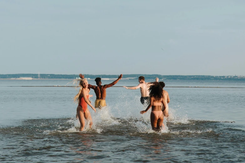 a group of people are playing in the water, by Carey Morris, pexels contest winner, slightly tanned, thumbnail, high quality image, rhode island