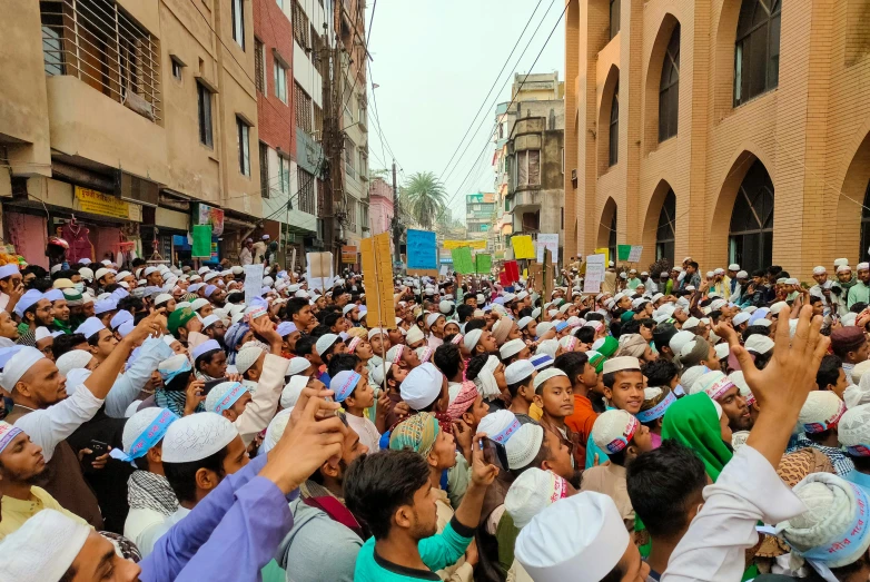 a large group of people standing in a street, a picture, hurufiyya, helmet view, bangladesh, profile image, placards