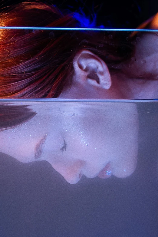 a close up of a person looking at a cell phone, an album cover, inspired by Gottfried Helnwein, trending on pexels, hyperrealism, portrait of a woman underwater, hibernation capsule close-up, the hair floats on the water, still image from tv series