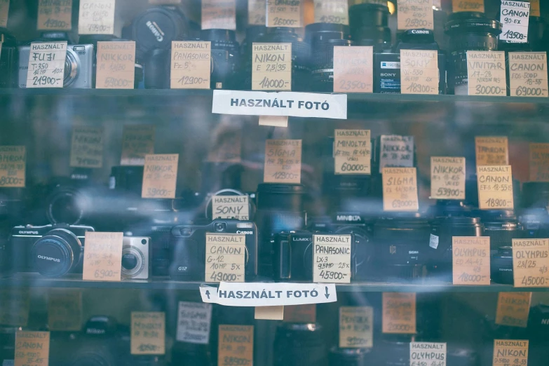 a display case filled with lots of different types of cameras, a picture, by Kristian Zahrtmann, unsplash contest winner, budapest, labels, on hasselblaad, lots of signs