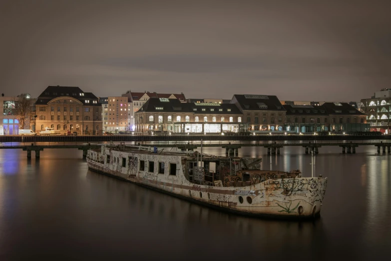 a boat that is sitting in the water, by Sebastian Spreng, unsplash contest winner, graffiti, low light museum, hasselblad, berghain, moored