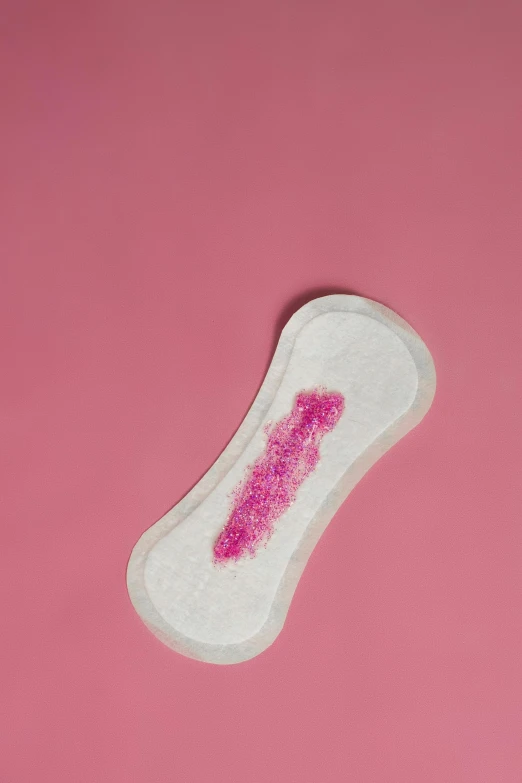 a sanitary pad on a pink background, a stipple, by Rachel Reckitt, trending on pexels, full body image, made of lab tissue, back arched, really long