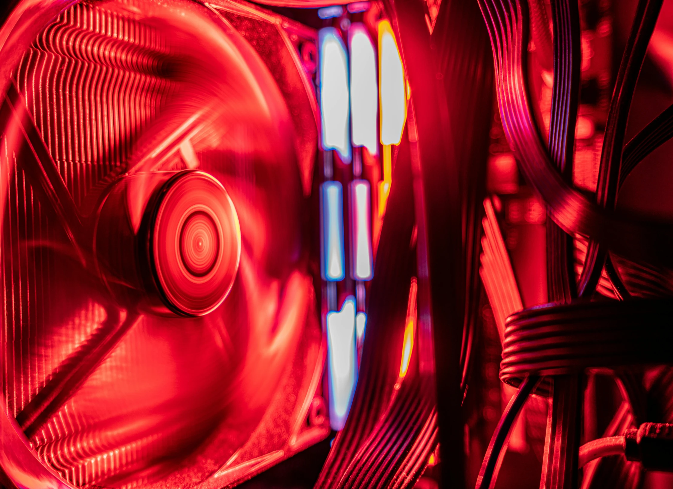 a close up of a fan inside of a computer case, by Adam Marczyński, bright colors with red hues, red and cinematic lighting, instagram post, water-cooled
