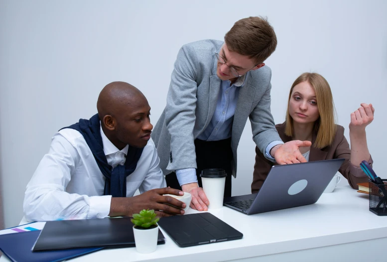 a group of people sitting around a table with laptops, by Adam Marczyński, pexels contest winner, avatar image, plain background, maintenance photo, concentrated