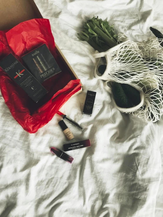 a bag of makeup sitting on top of a bed, inspired by Eden Box, instagram contest winner, some red accents, all black matte product, set on singaporean aesthetic, sports photo