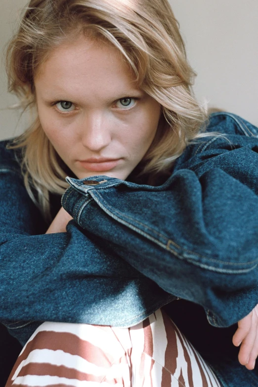 a close up of a person with a jacket on, trending on unsplash, photorealism, lara stone, denim, threatening pose, bedhead