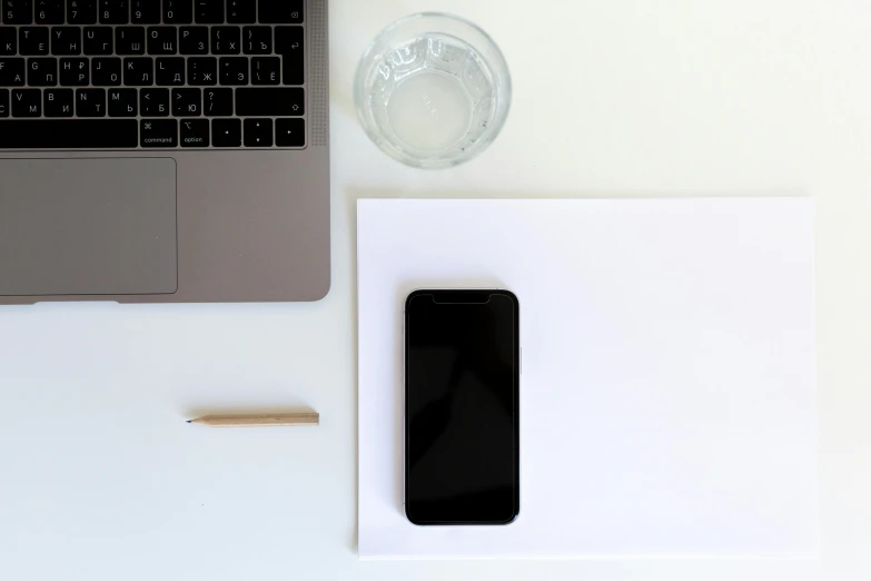 an open laptop computer sitting on top of a white desk, pexels, postminimalism, cell phone, square, black, professional iphone photo