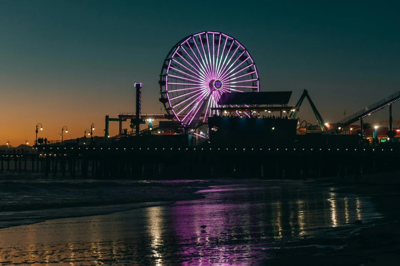 a ferris wheel sitting on top of a beach next to a pier, neon purple, flume, los angelos, profile image