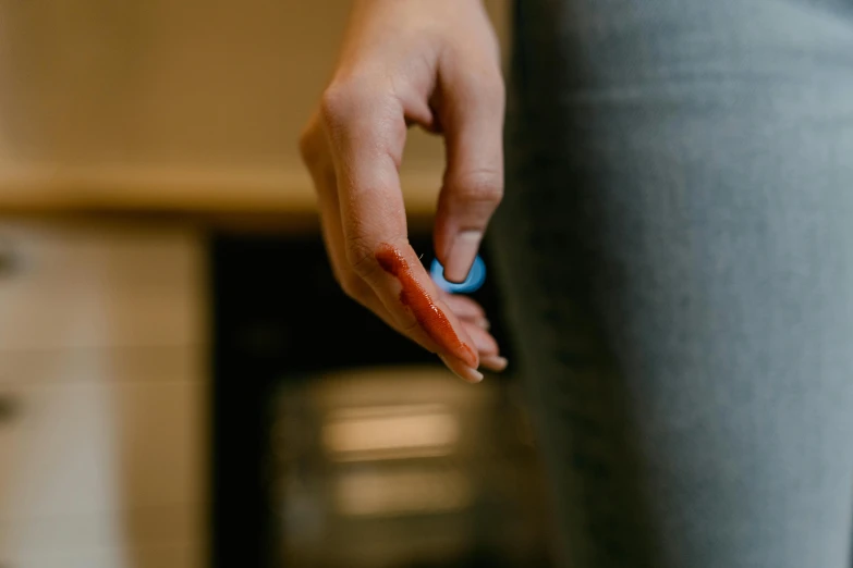 a close up of a person holding something in their hand, by Emma Andijewska, pexels contest winner, bloody knife, hot glue, casually dressed, injured