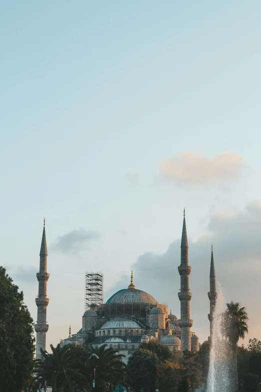 a large building with a fountain in front of it, an album cover, inspired by Altoon Sultan, pexels contest winner, hurufiyya, blue marble, asymmetrical spires, panorama view, sunfaded