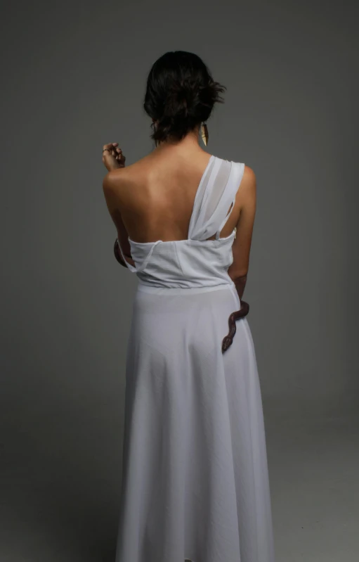 a woman in a white dress holding a knife, inspired by Theophanes the Greek, flickr, back view. nuri iyem, soft silk dress, side - view, wedding dress