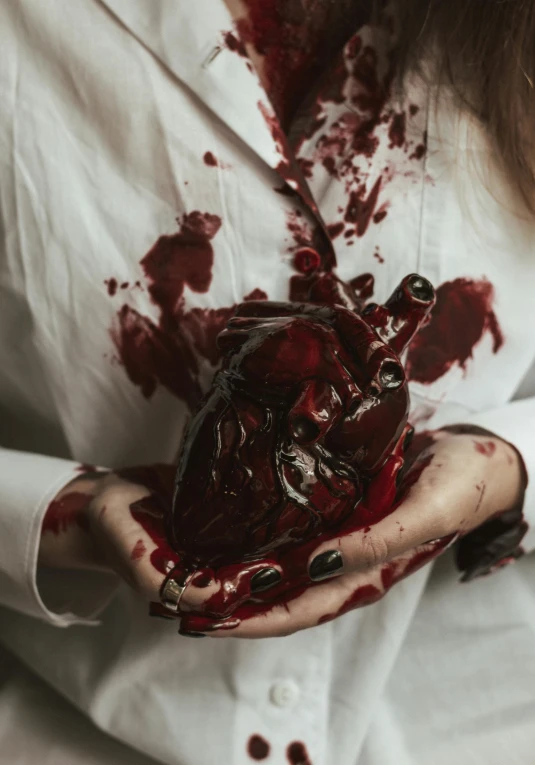 a woman holding a bleeding heart in her hands, inspired by Elsa Bleda, pexels contest winner, renaissance, blood stains on shirt, meat with veins, dark vhs gothic hearts, with a lab coat