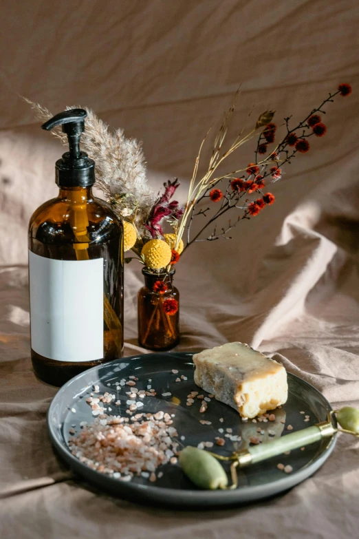 a plate that has some food on it, a still life, unsplash, renaissance, bottles covered in wax, skincare, textured base ; product photos, soap