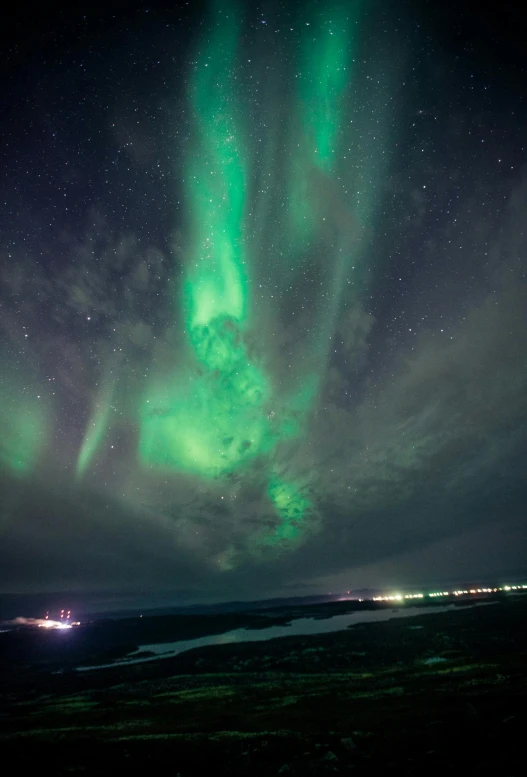 the aurora lights in the sky above a body of water, pexels contest winner, hurufiyya, neon signs in the distance, dark green, sitting on the cosmic cloudscape, scandinavian